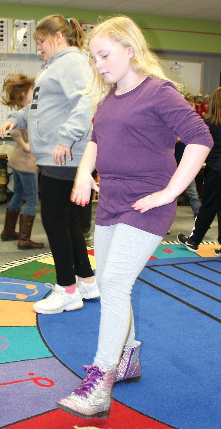 Jasmin Wilson, fourth-grade student at Ladoga Elementary, learns an old-fashioned folk dance Thursday during music class.
